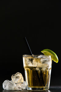 Close-up of beer glass against black background