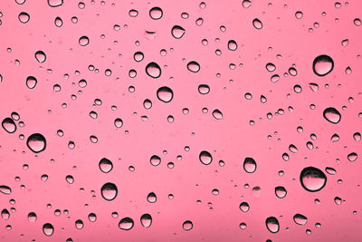 Rain drops on a window, drops of rain on blue glass background