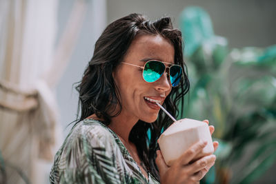 Portrait of a smiling young man drinking drink