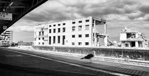 View of building in city against cloudy sky