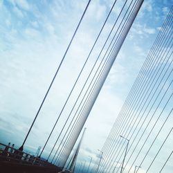 Low angle view of suspension bridge against sky