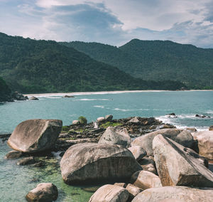 Scenic view of lake and mountains against sky