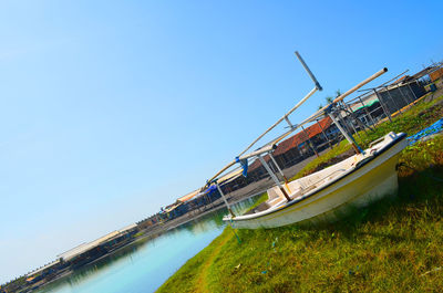 Panoramic view of canal against clear blue sky