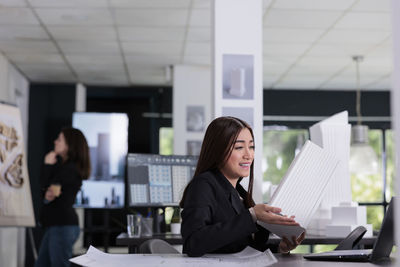 Portrait of young businesswoman using digital tablet in office