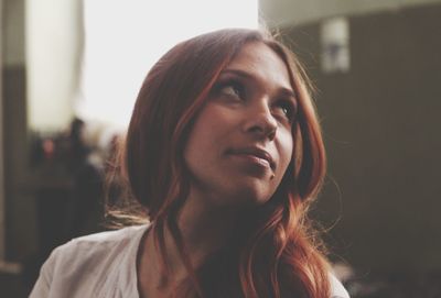 Close-up of thoughtful young woman at home