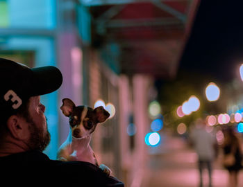 Portrait of man with illuminated hat at night