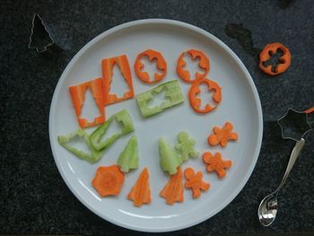 High angle view of pumpkin and vegetables on plate