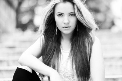Portrait of beautiful woman sitting outdoors