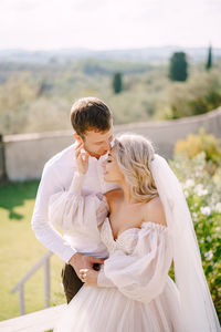 Newlywed couple embracing outdoors