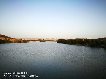 Scenic view of calm lake against clear sky