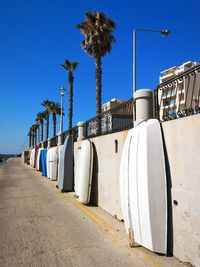 View of palm trees against clear blue sky