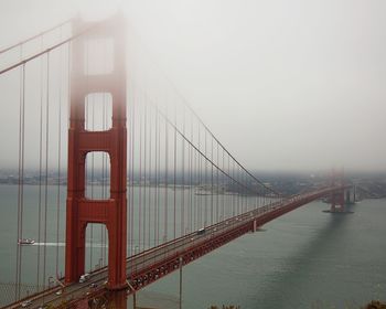 View of suspension bridge in foggy weather