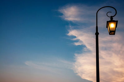 Low angle view of street light against sky
