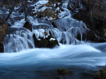 Stream flowing through rocks in forest