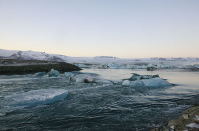 View of ice in lake against sky