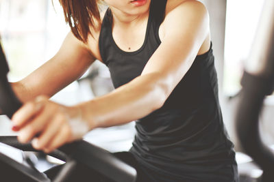 Close-up of woman exercising at gym