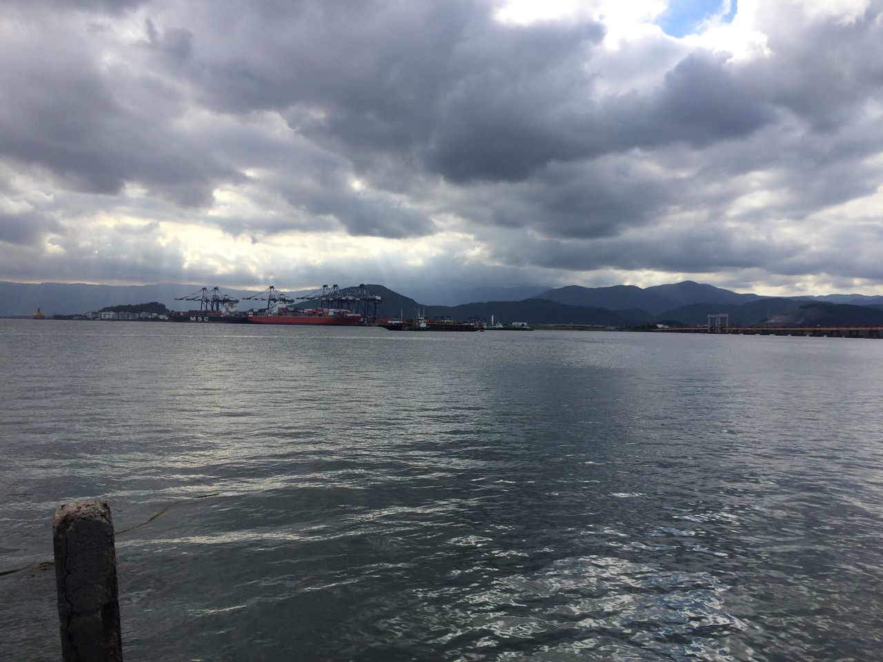 water, sea, sky, cloud - sky, tranquility, tranquil scene, cloudy, scenics, beauty in nature, cloud, rippled, waterfront, nature, pier, nautical vessel, horizon over water, idyllic, mountain, boat, outdoors