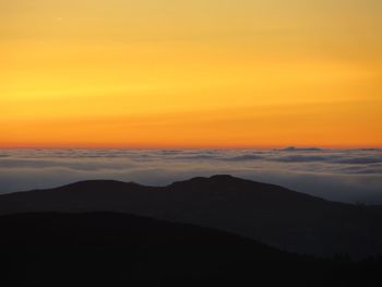 Scenic view of silhouette mountain against sky during sunset