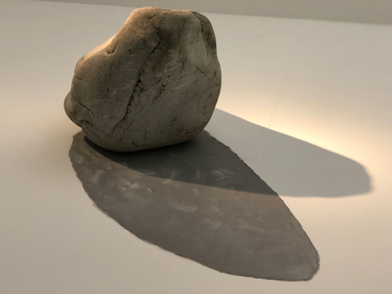 CLOSE-UP OF ROCK ON TABLE