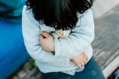 Child holding chick