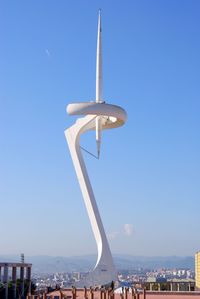 View of montjuic communications tower against blue sky