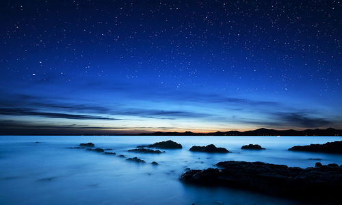 Scenic view of sea against sky at night