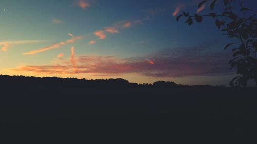 Silhouette landscape against scenic sky