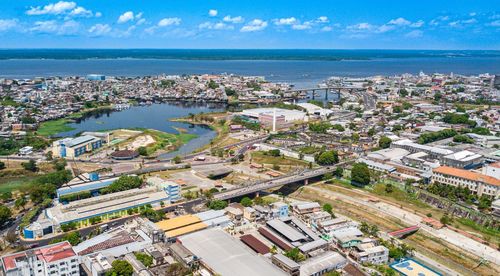 High angle view of buildings by sea against sky