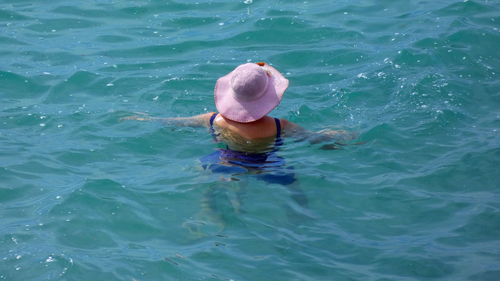 High angle view of woman swimming in sea