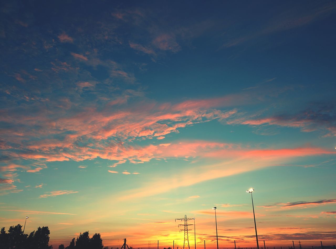 sunset, silhouette, sky, orange color, low angle view, beauty in nature, scenics, tranquility, cloud - sky, tranquil scene, nature, dramatic sky, cloud, idyllic, outdoors, no people, dusk, moody sky, electricity pylon, power line