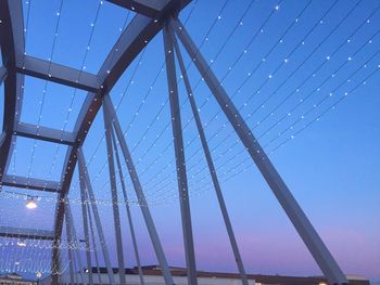 Low angle view of bridge against blue sky