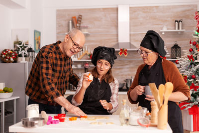Family preparing food in kitchen during christmas