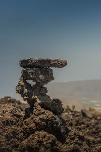 Stack of rocks against clear sky