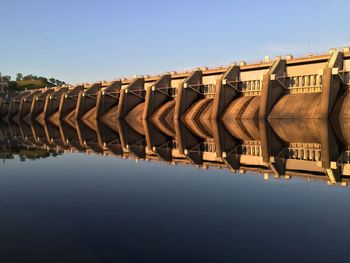 Panoramic view of row by river against clear sky