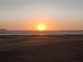 Scenic view of beach against sky during sunset