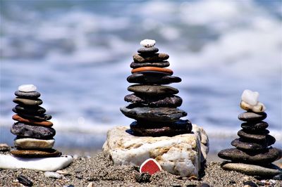 Stack of pebbles on rocks at sea shore