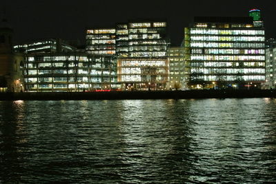 Reflection of illuminated buildings in water at night