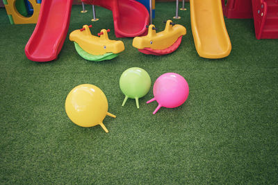 High angle view of colorful play equipment on turf