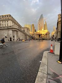 View of city street and buildings against sky