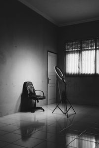 Empty chair against wall at home