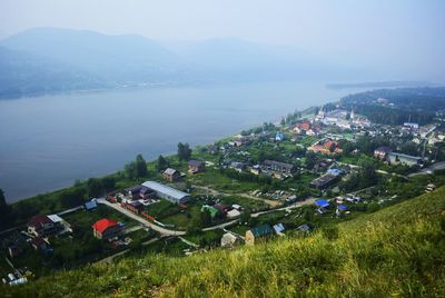 High angle view of sea and mountains against sky