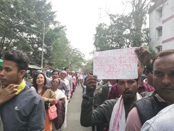 Portrait of people standing against trees