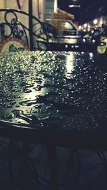 Reflection of trees in water on street