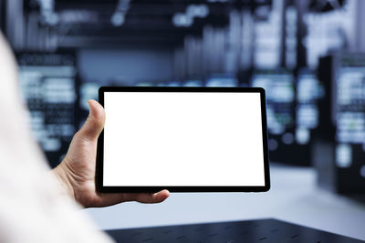 Midsection of woman using digital tablet
