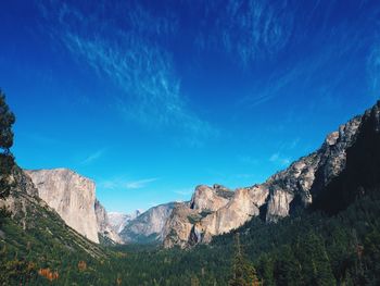 Scenic view of mountains against blue sky