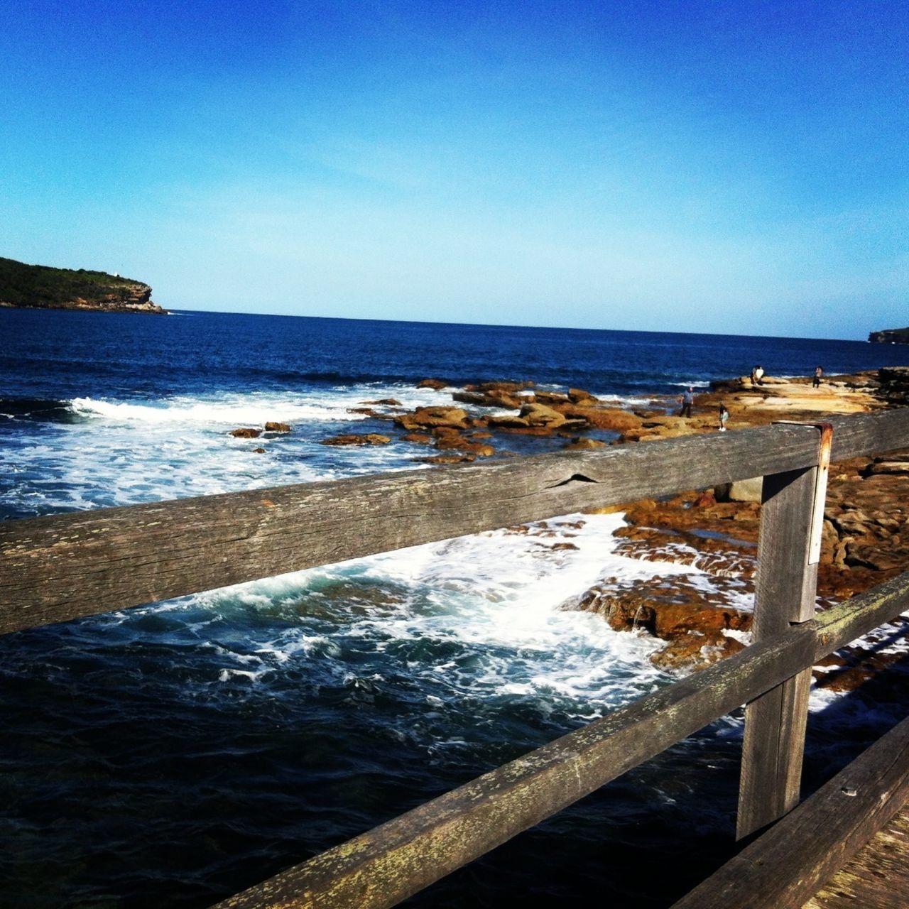 water, sea, clear sky, blue, scenics, tranquil scene, copy space, tranquility, horizon over water, beauty in nature, pier, nature, railing, idyllic, wood - material, beach, shore, calm, day, wave