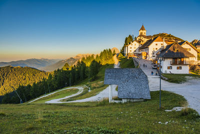 Mount lussari. fiery sunset over the sanctuary and the julian alps. italy