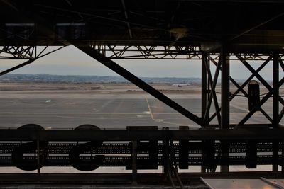 Airplane on airport runway against sky