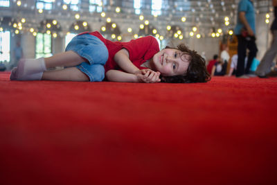 Full length portrait of woman relaxing on floor