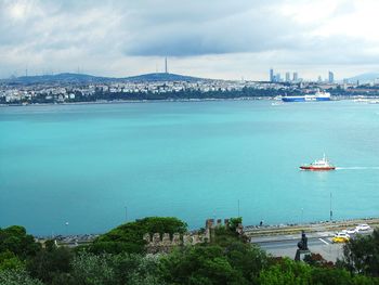 Scenic view of sea and buildings against sky